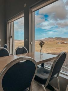 a dining room with a table and chairs and a window at Guesthouse Reynir in Reynir +32 photos