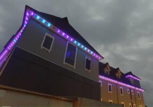 a building with purple and blue lights on it at Grand Diamond Hotels & Suites LTD in Owerri