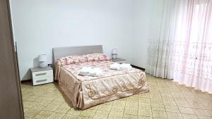 Postel nebo postele na pokoji v ubytování Casa Vacanze Nonna Tetta