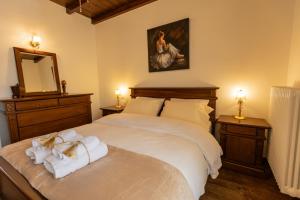 a bedroom with a bed with towels on it at Tihio Pool Villa & Spa in Tíkhion +31 photos