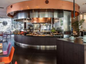 a restaurant kitchen with a buffet of food at Novotel Barcelona City in Barcelona