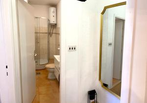 a bathroom with a toilet and a mirror at Apartments Derado in Supetar +39 photos