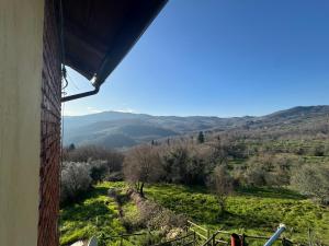a view from a window of a mountain view at Appartamento Zafferano in LʼOpaco