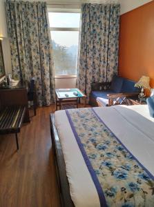 Postel nebo postele na pokoji v ubytování hotel Baljees Regency
