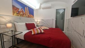 a bedroom with a red bed with a red blanket at Giudei House Torri in Bologna