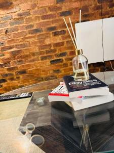 a glass table with a lamp on top of books at The Nook at Maboneng -24hr security, WiFi, cozy home in Johannesburg +44 photos