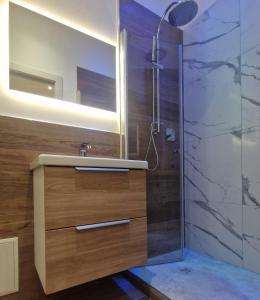 a bathroom with a sink and a shower at Giudei House Torri in Bologna