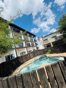a swimming pool in front of a building at The Nook at Maboneng -24hr security, WiFi, cozy home in Johannesburg