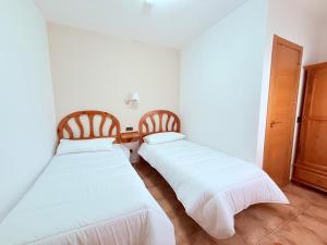 Postel nebo postele na pokoji v ubytování Hostal Castilla