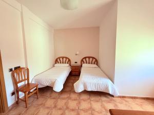 Postel nebo postele na pokoji v ubytování Hostal Castilla