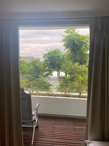 a window with a chair in a room with a view at Cristians lägenhet in Kata Beach