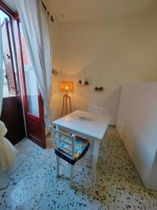 a room with a white table and a chair at La casa di Maria in Lipari