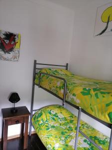 two bunk beds in a room with a table at Casa das 4 estações in Castelo Branco +4 photos