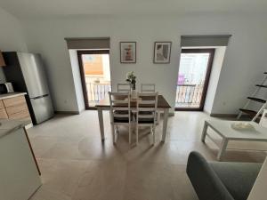 a kitchen and dining room with a table and chairs at Apartamento La Placeta in Alameda +4 photos