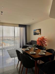 a living room with a table and chairs and a couch at Sea view Mercury Tower, Rooftop infinity Pool in St. Julianʼs