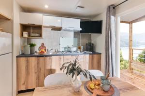 a kitchen with a table and a kitchen with a counter at Camping des Pierres Debout in Névez