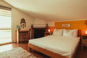 a bedroom with a bed and a table and a fireplace at New Wellness & Spa Boutique Residence Rovinj in Rovinj