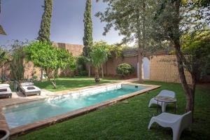 a swimming pool in the yard of a house at Villa Em in Marrakech +36 photos