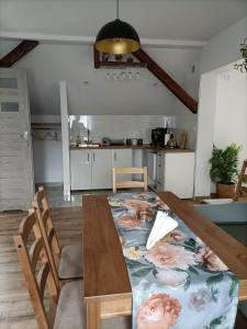 a dining room table with a flower blanket on it at Apartamenty w Stodole in Krościenko +27 photos
