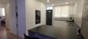 Una cocina con encimera negra en una habitación. en Apartamento Luxe Triana, en Sevilla