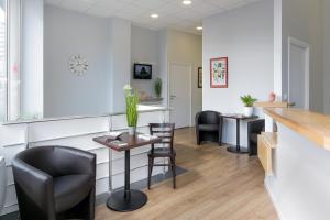 a waiting room at a clinic with chairs and a counter at Hotel Foch Nancy Gare in Nancy