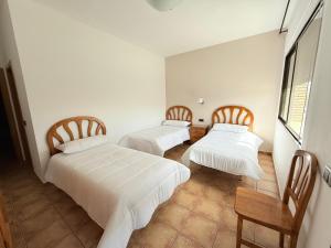 Postel nebo postele na pokoji v ubytování Hostal Castilla
