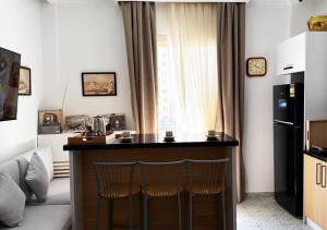 a small kitchen with a desk and two chairs at Marhaba Inn Hostel in Cairo