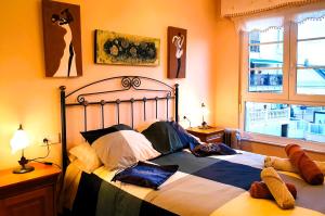 a bedroom with a bed with pillows and a window at Apartamentos SOL Y PLAYA Foz in Foz +61 photos