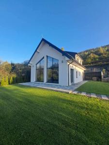 a house with a large lawn in front of it at Chalet Habovka in Habovka