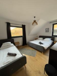 a bedroom with two beds and a window at Chalet Habovka in Habovka +38 photos