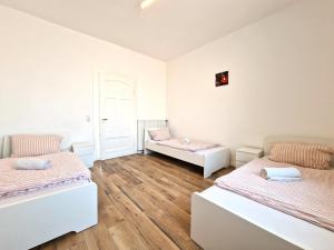 a room with two beds and a couch at Worker's Apartment in Leverkusen L1-4 in Leverkusen