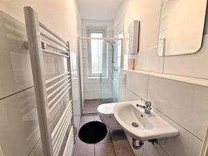 a white bathroom with a sink and a toilet at Worker's Apartment in Leverkusen L1-4 in Leverkusen +38 photos