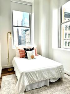 a bed in a room with a large window at KOT suites Inner Harbor in Baltimore