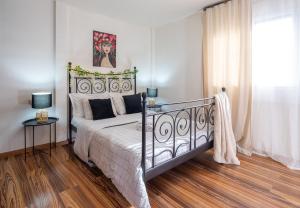 a bedroom with a bed with a metal frame at Cocomelo apts 3 luxury in Heraklio