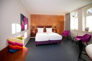 Postel nebo postele na pokoji v ubytování Kochs Stadthotel + 37 fotografií