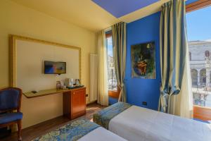 a hotel room with two beds and a window at Diamantino Town House in Padova