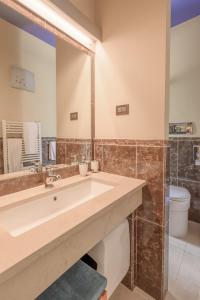 a bathroom with a sink and a large mirror at Diamantino Town House in Padova +65 photos