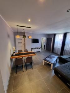 a living room with a table and chairs and a couch at Apartament exclusive Głuszyca in Głuszyca