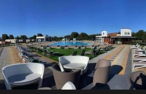a row of lounge chairs and a swimming pool at Tattershall Lakes 49 Larch View in Tattershall