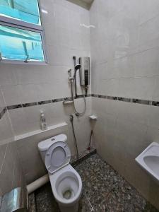 a bathroom with a toilet and a sink at Georgetown Homestay in George Town