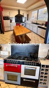 a kitchen with a stove and a wooden table at Le Clos Joli 15 in Molompize +8 photos