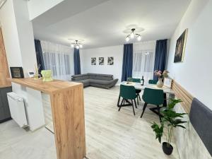 a kitchen and living room with a table and chairs at Luxury Apartments near Coresi Mall by GLAM in Braşov
