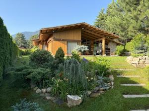 a garden in front of a log cabin at Villa - VALL DI VALL in Pirin Golf & Country Club in Razlog