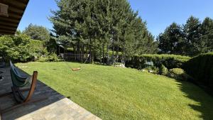 a yard with a bench in the grass at Villa - VALL DI VALL in Pirin Golf & Country Club in Razlog