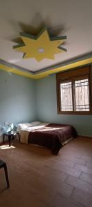 a bedroom with a bed with a star on the ceiling at Country House in Wadi Musa +8 photos