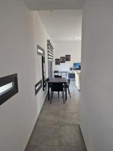 a dining room with a table in the middle of a room at George Apartments in Larnaca