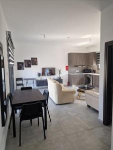 a living room with a couch and a table at George Apartments in Larnaca