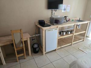 a small kitchen with a counter and a microwave at Akkerdam Bed and Breakfast in Calvinia