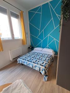 a bedroom with a bed and a blue wall at Fiera house Bologna in Bologna