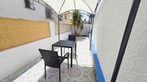 a balcony with two chairs and a table at Villa Nina in Mazarrón